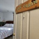 a peak into our spacious log cabin room with it's comfortable queen bed